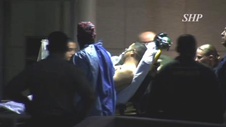 A Los Angeles County sheriffs deputy is wheeled away on a stretcher after he was shot while trying to detain a group of reported gang members in the Florence area of South Los Angeles on Friday, Nov. 16, 2012.