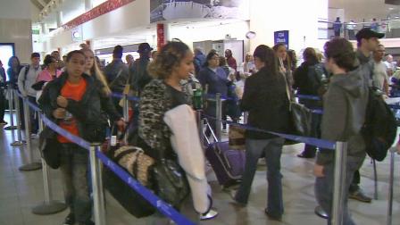 Travelers stand in line at the airport in this undated file photo.