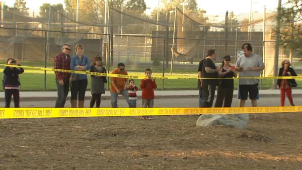 Passersby take a look at the wreckage of a small airplane that crashed on the California State University, Northridge, campus on Sunday, Nov. 25, 2012.