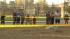 Passersby take a look at the wreckage of a small...