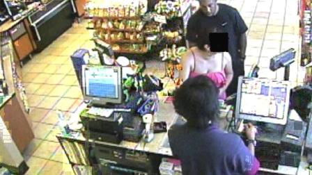 A surveillance camera image shows a suspect taking a photo of a woman at a Chevron station on North Sepulveda Boulevard in Manhattan Beach on Aug. 19, 2012.