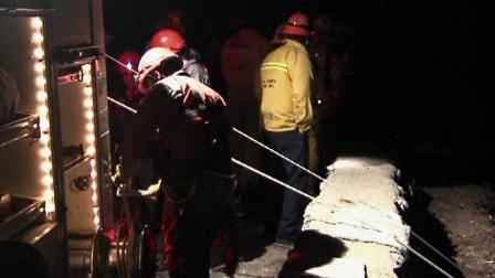 Officials are seen rescuing a man whose car plummeted 300 feet off a mountain road north of Glendora on Wednesday, Dec. 20, 2012.