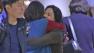 Two women are seen hugging at LAX on Tuesday, Dec. 25, 2012.