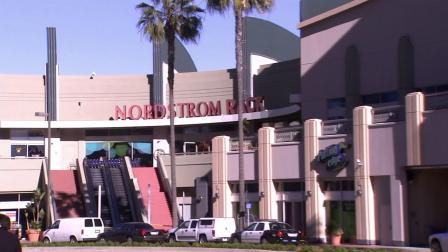 Police vehicles are seen outside the Nordstrom Rack at the Howard Hughes Center on Friday, Jan. 11, 2013, where 14 employees were held hostage.