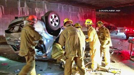 An emergency crew surrounds a car involved in a crash on the northbound lanes of the 110 Freeway in Los Angeles on Sunday, Jan. 20, 2013.