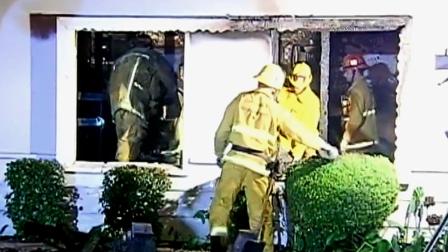 Firefighters are shown at the scene of a house fire in the 9100 block of Monogram Avenue in North Hills on Saturday, Jan. 26, 2013.