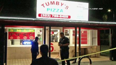 Investigators are shown outside of Tumbys Pizza in South Los Angeles following a fatal shooting on Thursday, Jan. 31, 2013.