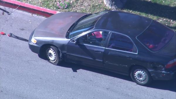 A suspect is seen filling a balloon with nitrous oxide at the end of a pursuit in Panorama City on Friday, Feb. 1, 2013.