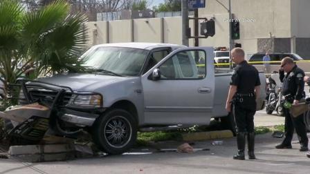 Officers are seen investigating the scene of a crash after an alleged car thief slammed head-on into a pole on Sherman Way in Winnetka while evading police on Saturday, Feb. 2, 2013.