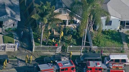 Firefighters are seen outside a house fire in South Los Angeles on Tuesday, Feb. 26, 2013.