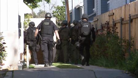 Officers are seen searching for two suspects who opened fire on deputies in Pasadena on Thursday, March 14, 2013.