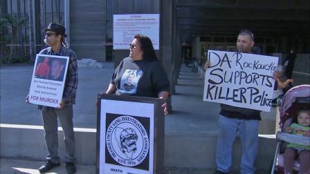 Genevieve Huizar, mother of Manuel Diaz, who was shot and killed by police on July 21, 2012, holds a protest in front of the central courthouse in Santa Ana Thursday, March 21, 2013.