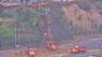 Caltrans bulldozers are seen cleaning up from a landslide at Temescal Canyon Road and PCH in Pacific Palisades on Thursday, March 21, 2013.