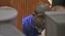 Terrence Meeks hides behind computer monitors in court during his arraignment hearing on Monday, March 25, 2013.