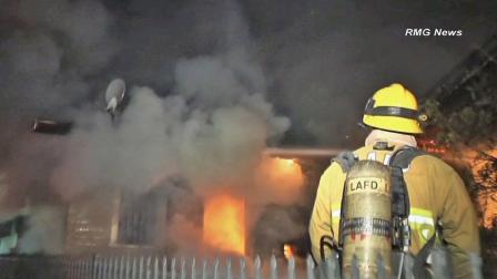 A firefighter works to put out a house fire in the 1900 block of Scott Avenue in Echo Park on Thursday, March 28, 2013.