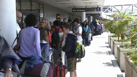 Travelers stand in line at Los Angeles International Airport on Tuesday, April 23, 2013.