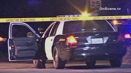 Crime tape is shown behind a law enforcement vehicle at the scene of an officer-involved shooting in Long Beach on Sunday, April 28, 2013.