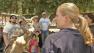 A woman holds an owl as people gather to learn about the bird at the Pierce College Farm Walk on Sunday, April 28, 2013.