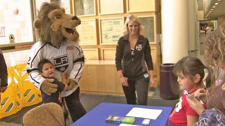 Bailey, the Los Angeles Kings mascot, hugs a child during a team event in this undated file photo.