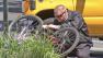 A law enforcement official inspects a bicycle that was involved in a fatal bus crash in at the intersection of Columbus Avenue and Riverdale Drive in Glendale on Thursday, May 2, 2013.