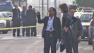 Investigators are seen outside an apartment where three people were shot and killed in Harbor Gateway Friday, May 10, 2013.