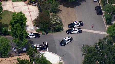 Police search for two robbery suspects in a Tarzana neighborhood on Thursday, May 23, 2013.