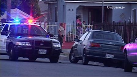 A deputy is seen standing in front of a home after a deputy-involved shooting in Compton on Thursday, May 23, 2013.