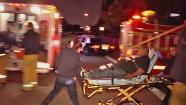 A man is wheeled out in a gurney following a shooting at a party in East Los Angeles on Saturday, May 25, 2013.