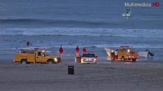 A small boat containing nearly a ton of drugs washed ashore in Manhattan Beach on Saturday, May 25, 2013.