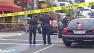 Police officers investigate the scene of a stabbing outside a sushi restaurant in Belmont Shore on Saturday, June 8, 2013.