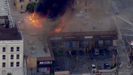 Firefighters respond to a fire at a pet store in the 1100 block of North Vermont Avenue in Los Angeles on Monday, June 10, 2013.