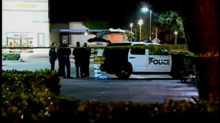 Pasadena police officers stand near the scene of a fatal officer-involved shooting involving a robbery suspect on Saturday, March 24, 2012.