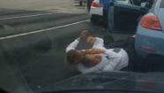 Two men dressed in business attire got out of their cars and fought on a busy Van Nuys street.