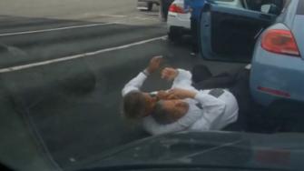 Two men dressed in business attire got out of their cars and fought on a busy Van Nuys street.