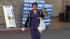 A shopper walks out of a Los Angeles-area grocery store holding a single-use plastic bag.