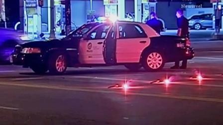 A Los Angeles police patrol vehicle is shown near Burbank Boulevard and White Oak Avenue in Encino. Police say two suspects in a vehicle tried to run down an officer on Thursday, June 20, 2013.