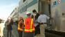 Metrolink officials help a woman off a train in the Burbank area on Friday, June 21, 2013.