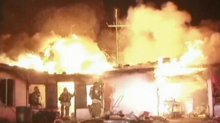 Firefighters battle a house fire on the 39300 block of 180th Street in Lake Los Angeles on Thursday, July 4, 2013.