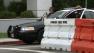 Hawthorne police stand guard as a protest gets under way on Saturday, July 6, 2013, over the shooting of a dog by an officer.