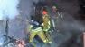 Firefighters work to put out flames at a Mid-City prop rental company on the 1100 block of South La Brea Avenue near Edgewood Place on Wednesday, July 17, 2013.