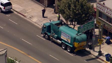 Police investigate after a city trash truck struck and killed a woman in the Lincoln Heights area on Monday, July 22, 2013.