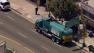 Police investigate after a city trash truck struck and killed a woman in the Lincoln Heights area on Monday, July 22, 2013.