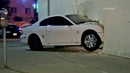 A car slammed into a martial arts school in Van Nuys, crashing straight through the wall of the building on Tuesday, July 23, 2013.