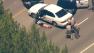 California Highway Patrol officers take a suspect into custody following a high-speed chase on the 118 Freeway on Wednesday, July 31, 2013.