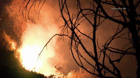 A man was killed and a woman injured in a vehicle crash that sparked a small brush fire in the Angeles National Forest on Friday, August 16, 2013.