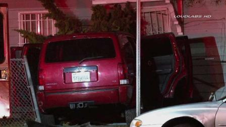 Authorities respond to the scene of a car crash near Normandie Avenue and 90th Street in South Los Angeles Sunday, Aug. 25, 2013.