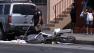 A police officer combs through evidence after a traffic collision on the 400 block of East Colden Avenue in South Los Angeles on Sunday, Sept. 1, 2013.