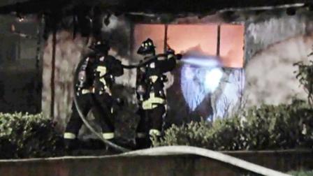 Firefighters battle a house fire on the 1900 block of East Eckerman Avenue on Wednesday, Sept. 11, 2013.