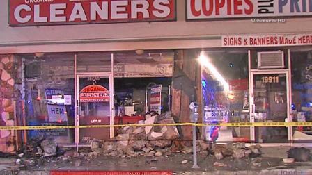 Police tape ropes off a dry-cleaning business on the 19900 block of Ventura Boulevard in Tarzana following a car crash on Thursday, Sept. 12, 2013.