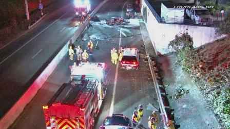 Emergency officials gather at the scene of a fatal car pile-up on the 10 Freeway in Santa Monica on Saturday, Sept. 14, 2013.
